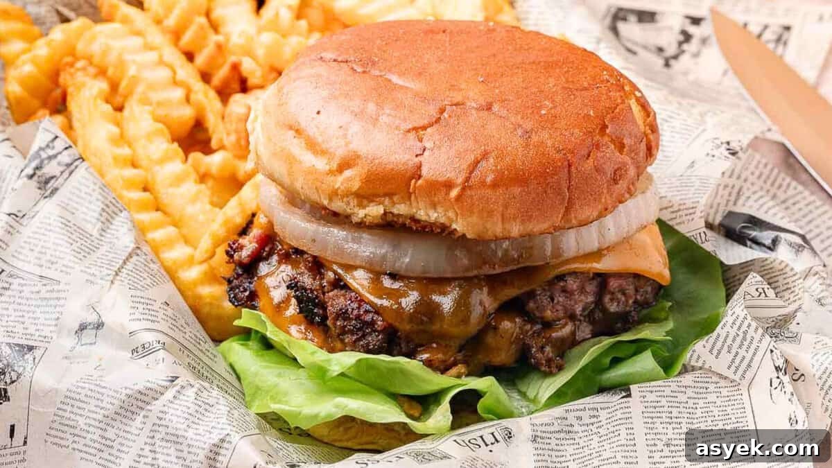 Smashed crack burgers with crisp edges and melted cheese stacked on toasted buns.