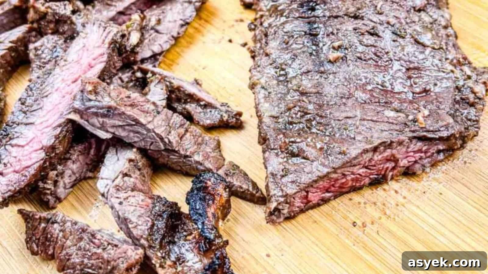 A sliced and grilled Carne asada on a wooden cutting board.