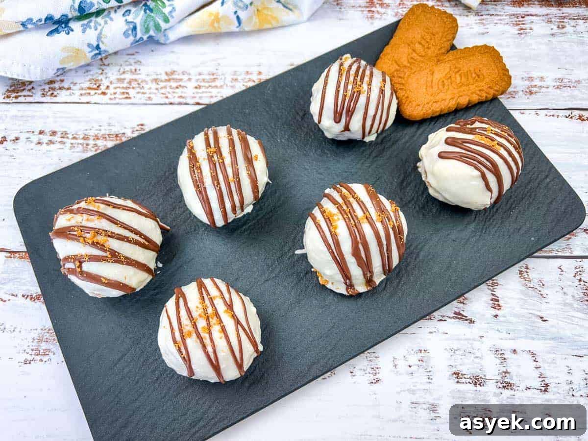 Six Cookie Butter Cake Balls on a slate tray.