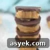25+ Dairy-Free, Gluten-Free Protein Desserts 11 Peanut butter cups topped with chocolate and stacked.