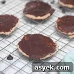 25+ Dairy-Free, Gluten-Free Protein Desserts 29 Chocolate coated protein thin mint cookies on a wire rack.