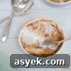 25+ Dairy-Free, Gluten-Free Protein Desserts 37 Pumpkin mug cake in a ramekin with coconut cream on top and a spoon in the cake.