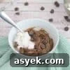 25+ Dairy-Free, Gluten-Free Protein Desserts 38 Chocolate brownie with chocolate chips in a white ramekin with coconut whip cream on top and a spoon in it.