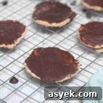 25+ Dairy-Free, Gluten-Free Protein Desserts 10 Chocolate coated protein thin mint cookies on a wire rack.