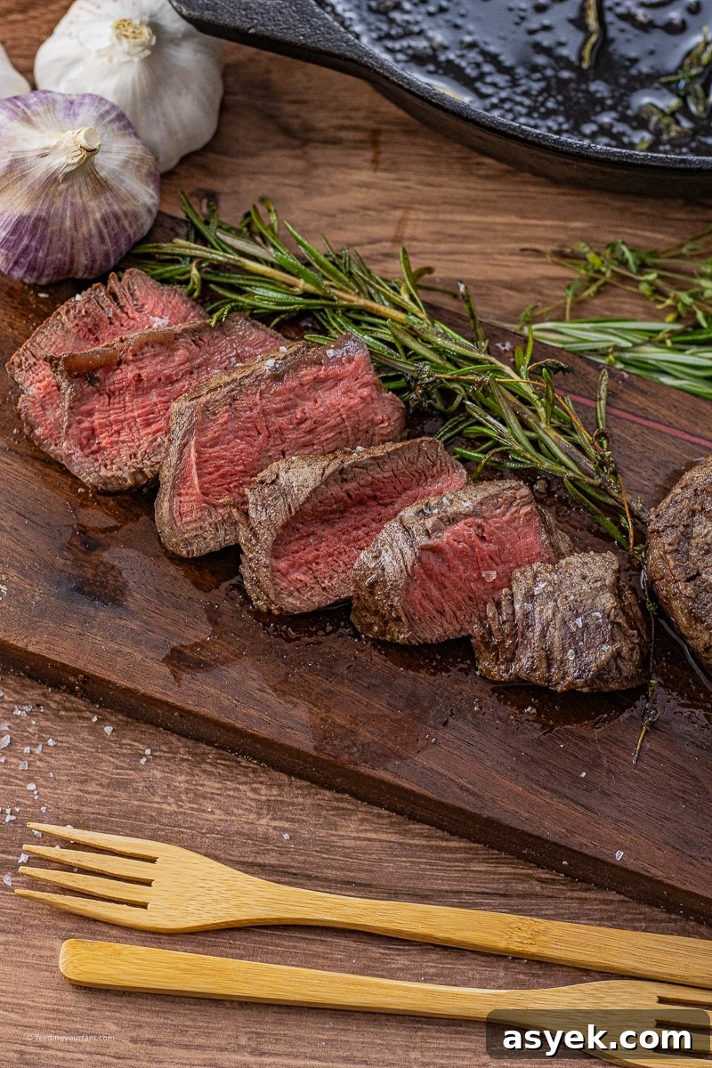sliced filet mignon on a wooden cutting board