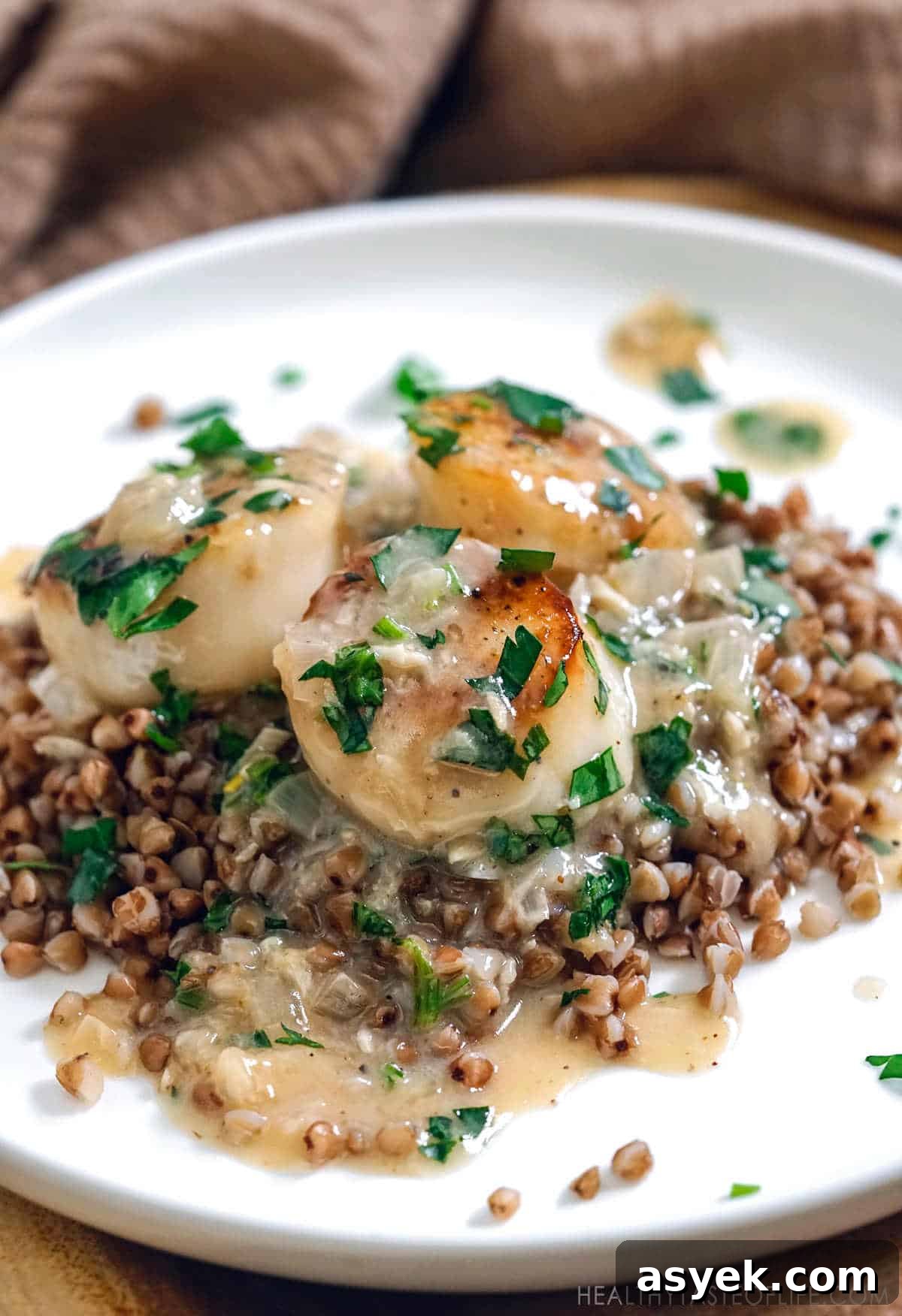 Whole30 Scallops with Dairy-Free Cream Sauce 8 Gluten free scallops dinner: pan seared scallops with dairy free white sauce served over buckwheat.