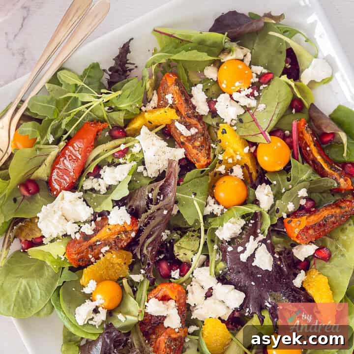 A square photo of a salad with feta, golden berries, sun-dried tomatoes and orange